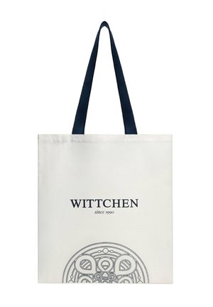 Bílá taška přes rameno s tmavě modrými uchy, textem "WITTCHEN since 1990" a kruhovým ornamentálním vzorem ve spodní střední části.