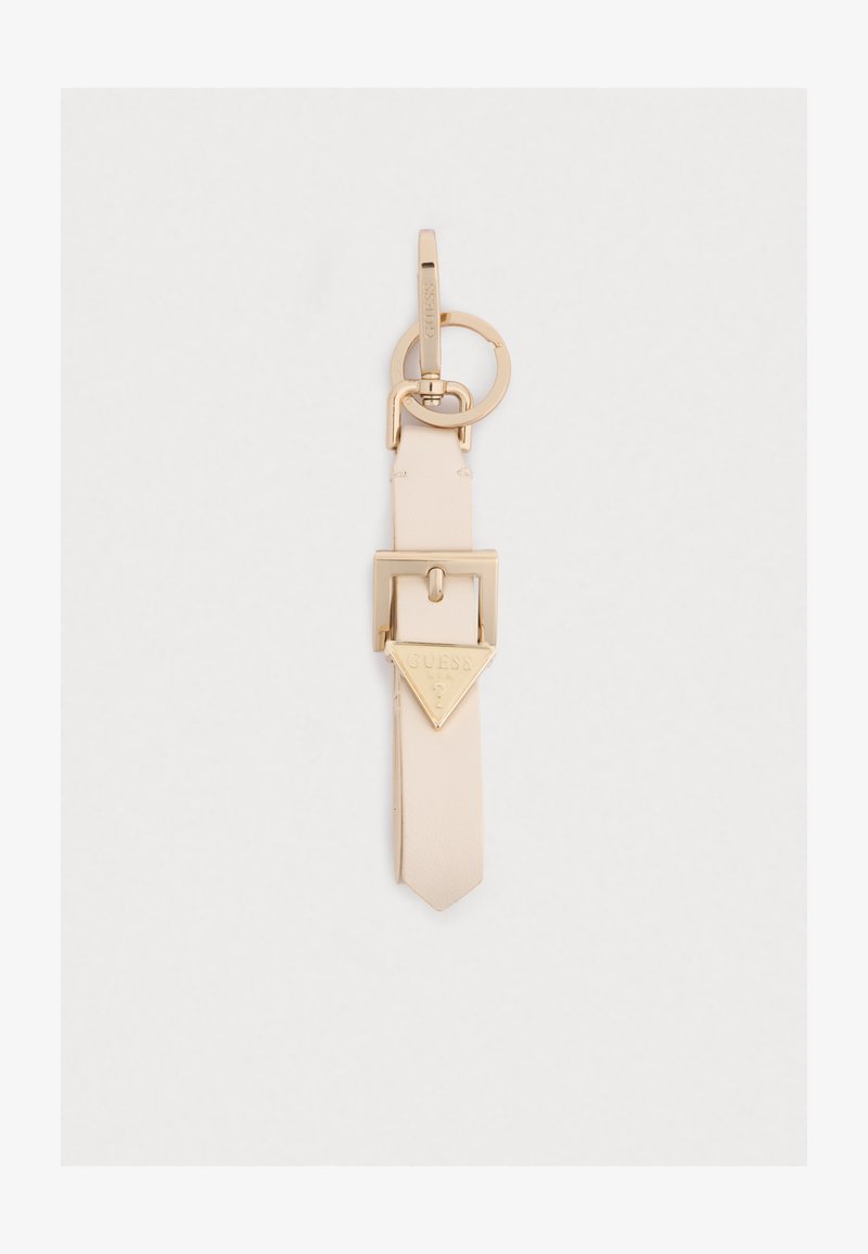 Keychain accessory with a light beige leather strap, gold-tone hardware, featuring a triangular gold emblem with "GUESS" branding.