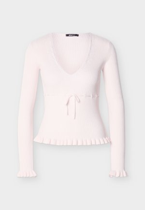Light pink ribbed sweater with long sleeves, a deep V-neck, a tie at the waist, and ruffled hem and cuffs. Soft texture and fitted design.