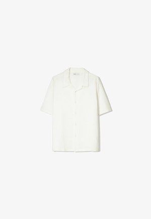 Short-sleeve, button-up shirt in off-white, featuring a soft, textured fabric, open collar, and relaxed fit.