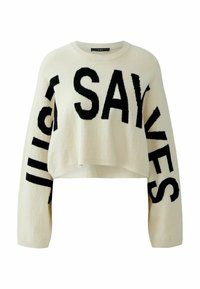 Cream-colored, cropped sweater with black block lettering "JUST SAY YES" on sleeves. Soft texture, round neckline, and ribbed cuffs.