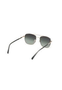 Metalen zonnebril met een gouden frame, gradient grijze lenzen en dunne groene armen. Verstelbare neuspads voor comfort en pasvorm.