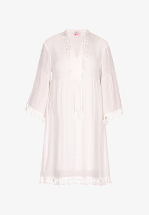 Fehér tunika ruha könnyű anyagból, V-nyakkal, a fronton fodros részletekkel és bojtos díszítésekkel az ujjakon és az alján.