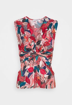 Sleeveless blouse with V-neck, knot detail at waist, and vibrant red, pink, black, blue, and beige leaf pattern on white background.