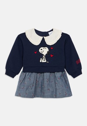 Navy sweatshirt dress with a white frill collar, Snoopy graphic, and red heart accents. Skirt features a blue patterned fabric with small flowers.