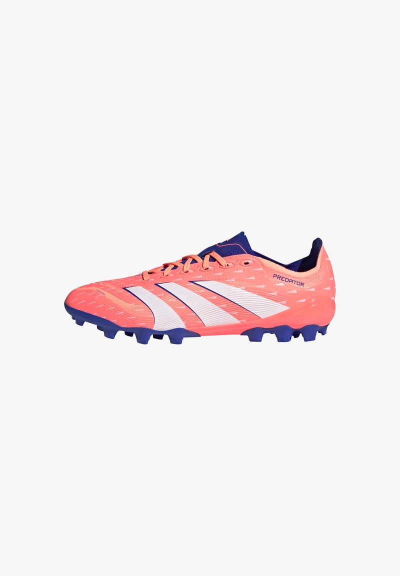 Bright pink football boot with white stripes and navy accents, textured upper, and molded studs for traction. Features a sleek, streamlined design.