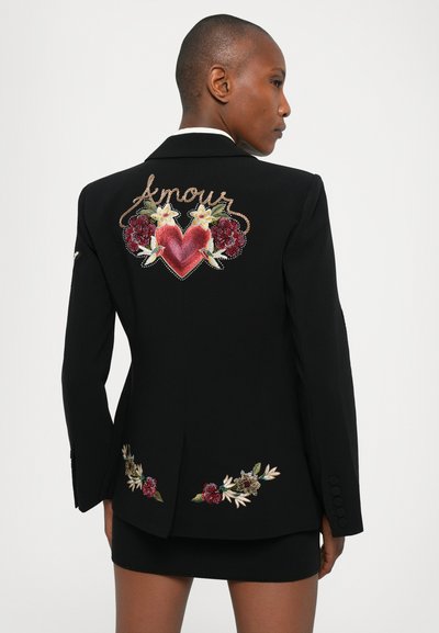 Black blazer featuring intricate floral embroidery, a heart design with "Amour" script, and a fitted silhouette.