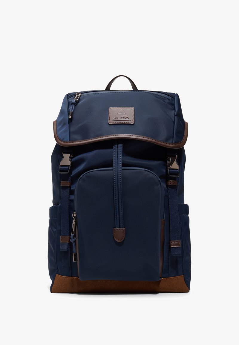 Laivastonsininen reppu, jossa vetoketjutasku edessä, ruskea pohjakoriste, yläkantti napilla, sivutaskut ja Aldo-logolla varustettu läppä.