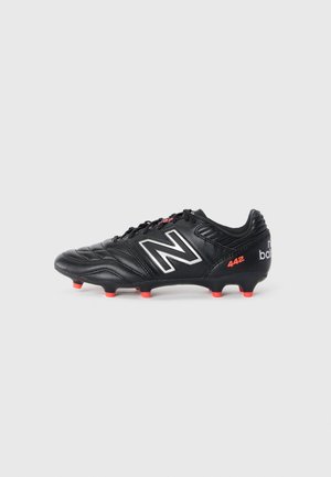 Black soccer cleat with a textured leather upper, featuring a silver "N" logo, red accents, and rubber studs on the outsole for traction.