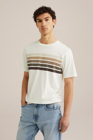 Short-sleeve cream T-shirt featuring horizontal stripes in beige, brown, and dark green. Smooth cotton fabric with a relaxed fit.