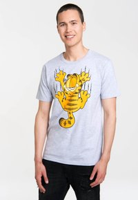 Grey cotton t-shirt with a large yellow cartoon cat graphic. Short sleeves, crew neck, relaxed fit, and visible stitching details.