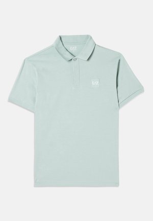 Világos menta zöld póló, puha pamutból készült, klasszikus gallérral, rövid ujjakkal és egy kis hímzett logóval a bal mellen.