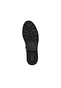 Semelle extérieure en caoutchouc noir avec un motif de relief texturé, présentant diverses formes pour la prise en main et l'adhérence. Logo en relief sur le talon.