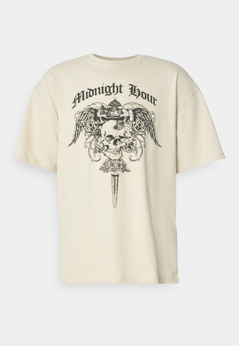 Cream-colored oversized t-shirt with a black graphic of a skull, wings, and flowers, featuring the text "Midnight Hour" above the design.