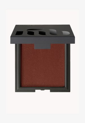 Brown blush powder in a square black compact with a textured finish. The lid features cut-out lettering. Compact dimensions are small and portable.