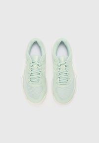 Light green athletic shoes with a mesh upper, round toe shape, white accents, and traditional lacing system. Soft rubber sole.