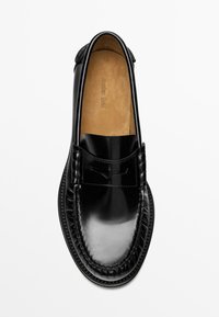 Black leather penny loafer with polished finish and brown insole, displayed from top view on a plain background.