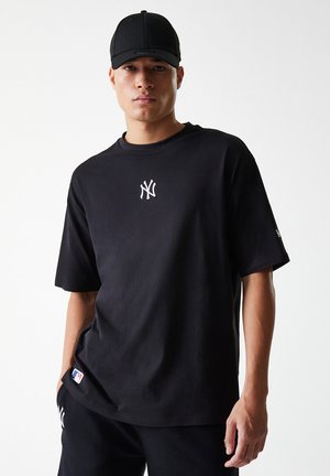 Black cotton t-shirt with a round neck, short sleeves, and a white NY logo on the chest. Paired with matching black shorts.
