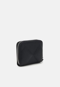 Black zippered wallet with a quilted pattern, made of smooth material, featuring silver hardware and a rectangular shape.