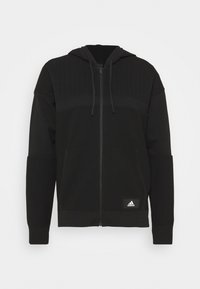 Sudadera con cremallera negra y diseño texturizado, con capucha, mangas largas y un pequeño logo en el dobladillo frontal. Fabricada con un tejido transpirable.
