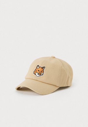 Beige baseball cap with a detailed embroidered fox head on the front, displayed against a plain white background.