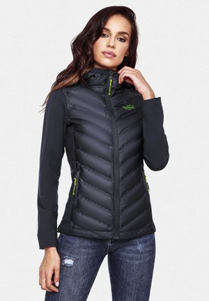 Black padded jacket with a high collar, featuring a chevron design, green zippers, and side pockets. Lightweight fabric with a smooth texture.