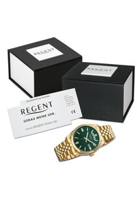 Montre bracelet en or avec un cadran texturé vert, des index d'heure argentés et un affichage de date, présentée dans deux boîtes noires avec des étiquettes "REGENT".