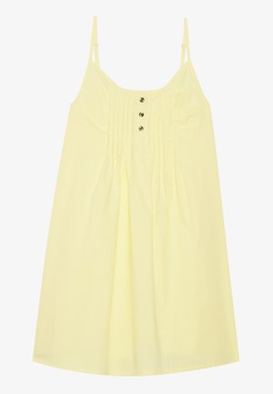 Robe d'été en coton jaune avec des bretelles fines et réglables, un buste froncé et trois boutons décoratifs au centre. Silhouette en A.