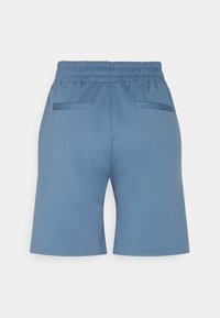 Blue shorts with an elastic waistband, two back pockets, and a smooth fabric texture. The cut is relaxed and knee-length.