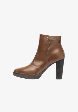 Brown leather ankle boots with a pointed toe, high block heel, and stitched accents. Includes small metallic detailing near the ankle.