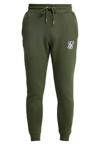 Olivgrüne Sweatpants aus weichem Stoff, mit einem gerippten Bund, Kordelzug und weißem Logo auf dem linken Oberschenkel.