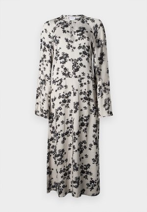 Blomstrete midi kjole i beige stof, med sort blomstermønster, rund halsudskæring, lange ærmer og en let udvidet silhuet.
