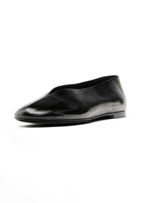 Chaussure plate en cuir noir avec un bout arrondi et un design minimaliste. Présente une finition lisse et une semelle basse. Pas de matériel ou d'accents visibles.