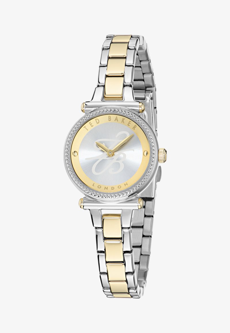 Reloj metálico en tonos plateado y dorado con una carátula redonda, esfera de un plateado claro texturizado, acentos dorados y un bisel engastado de cristales.