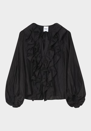 Blouse noire à manches longues avec volant sur le devant et le col, manches bouffantes resserrées aux poignets, et petit lien au col.