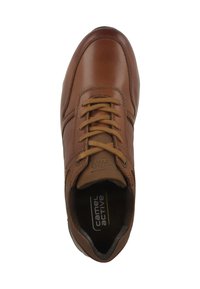 Brown leather shoe with round toe, perforated accents, and beige laces. Features cushioned insole and rubber sole for grip.
