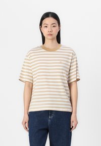 Striped T-shirt in cream and light brown with a ribbed crew neck. Relaxed fit, short sleeves, and a small logo embroidered on the chest.