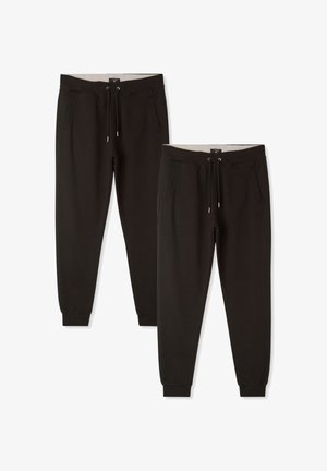 Czarne spodnie dresowe z mieszanki bawełny, z elastycznym paskiem w talii, dwiema bocznymi kieszeniami i elastycznymi mankietami przy kostkach.