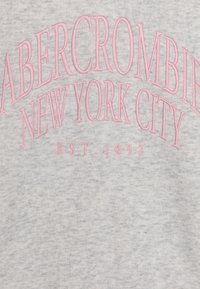 Szara bluza z kapturem z różowym haftowanym napisem "ABERCROMBIE NEW YORK CITY" oraz "EST. 1892" w zakrzywionym układzie.
