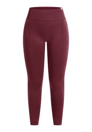Bordowe legginsy z wysokim elastycznym pasem, eleganckim krojem, gładką fakturą i subtelnymi detalami na bocznych szwach, które dodają stylu i dopasowania.