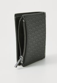 Black textured leather wallet with a zip closure, featuring embossed patterns and a silver zipper pull. Compact and rectangular design.