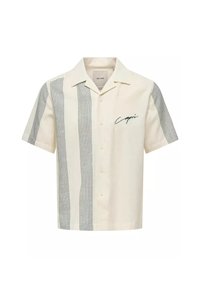 Camisa de manga corta en color crema, con rayas verdes verticales y un logotipo manuscrito "Capri" en el pecho, hecha de tejido ligero.