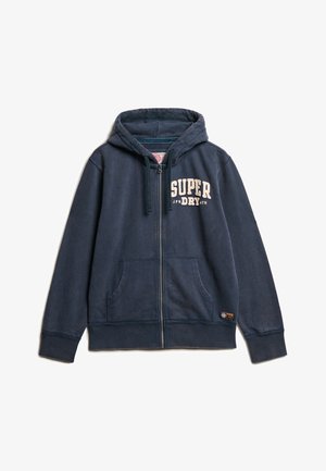 Navy blue zip-up hoodie made of soft fabric. Features a front pocket, hood with drawstring, and white logo text on the chest.