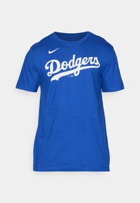T-shirt in cotone blu con un logo "Dodgers" bianco in un font curvo. Collo rotondo, maniche corte e vestibilità regolare.