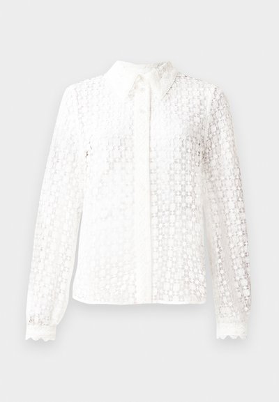 White blouse made of lace-like fabric, featuring a classic collar, long sleeves with scalloped cuffs, and a button-down front with decorative accents.
