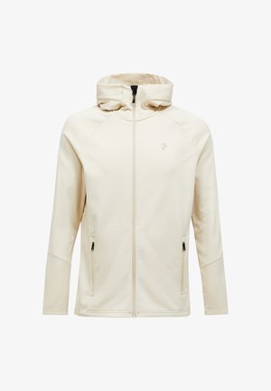 Creme zip-hoodie med høj krave, raglanærmer og to sidelommer. Har diskret branding på brystet og en glat tekstur.