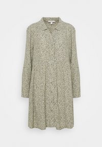 Pitkähiha, napillinen mekko vaaleanvihreänä, jossa on hajallaan mustia ja beigejä pilkkuja. Mekko on rento ja pleatattu.