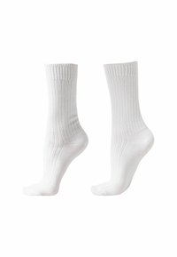 Weiße Baumwollsocken mit gerippter Textur, Knöchelhöhe und verstärktem Zehen- und Fersenbereich. Entwickelt für Komfort und Langlebigkeit.