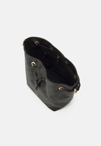 Black checkered bucket bag made of textured leather, featuring gold hardware, drawstring closure, and an interior pocket.