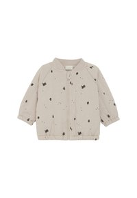 Veste zippée beige clair avec un motif tacheté noir, col côtelé, et poignets et ourlet élastiqués, fabriquée en tissu doux.